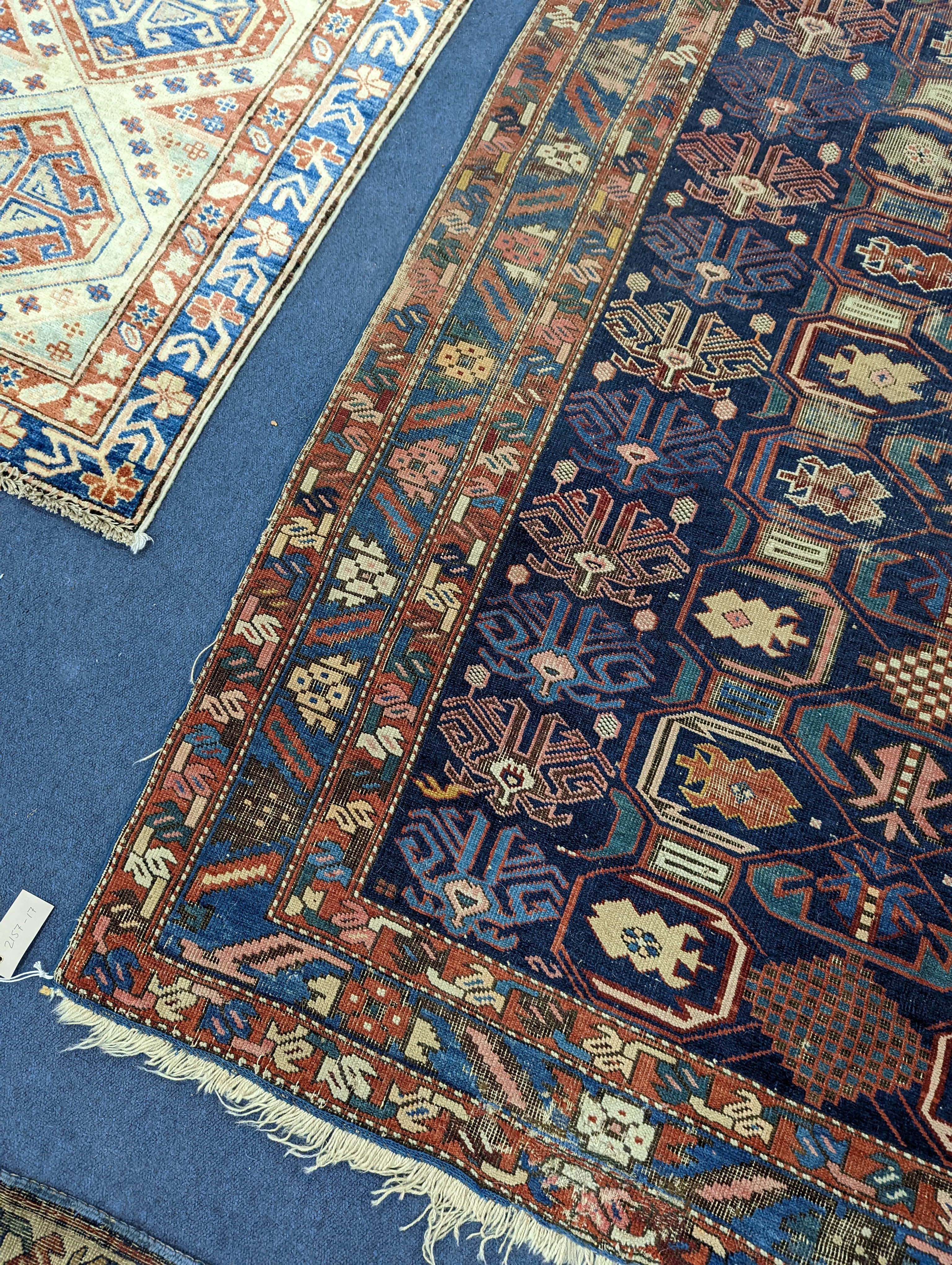 An antique Caucasian blue ground rug, 260 x 130cm